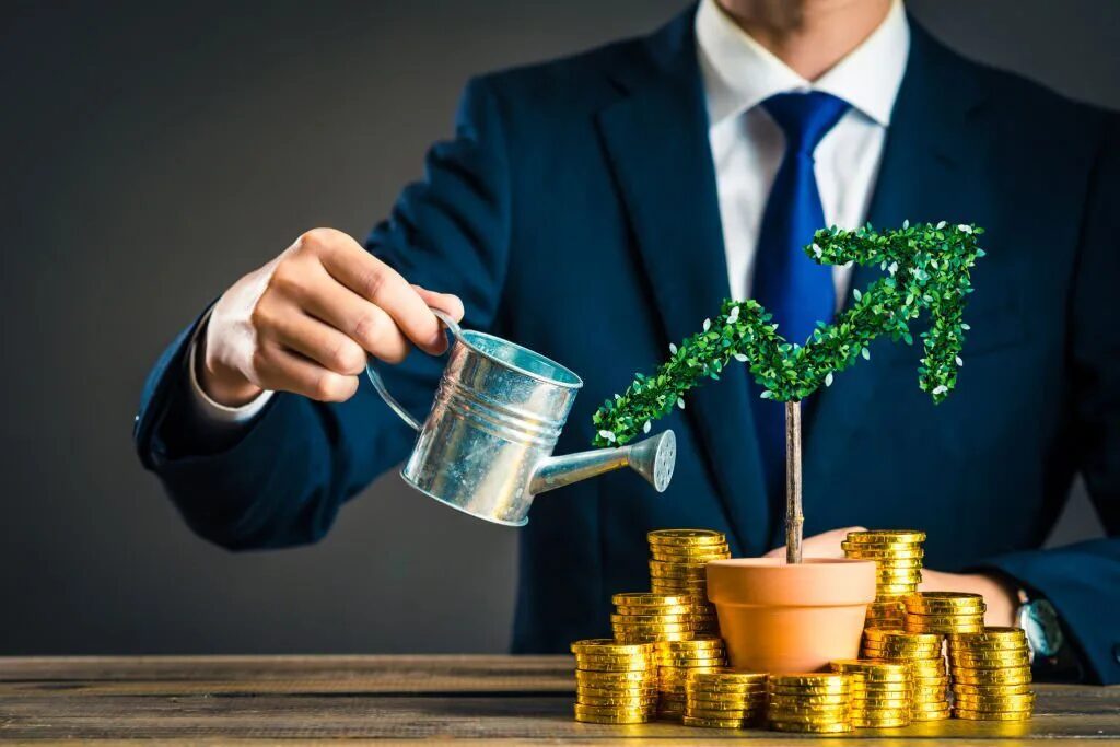 Man watering arrow-shaped tree in pot surrounded by coins