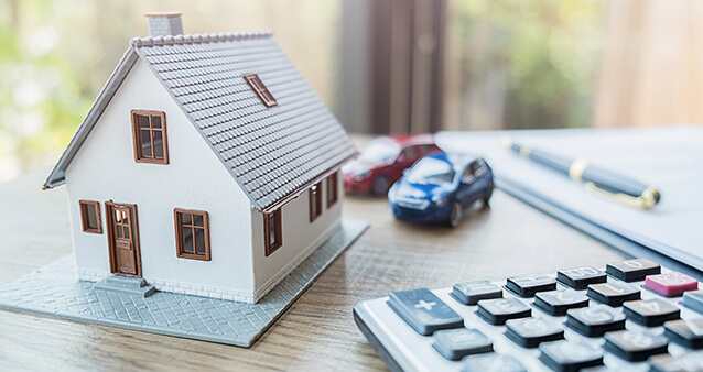 Calculator, house, two cars, pen, and paper